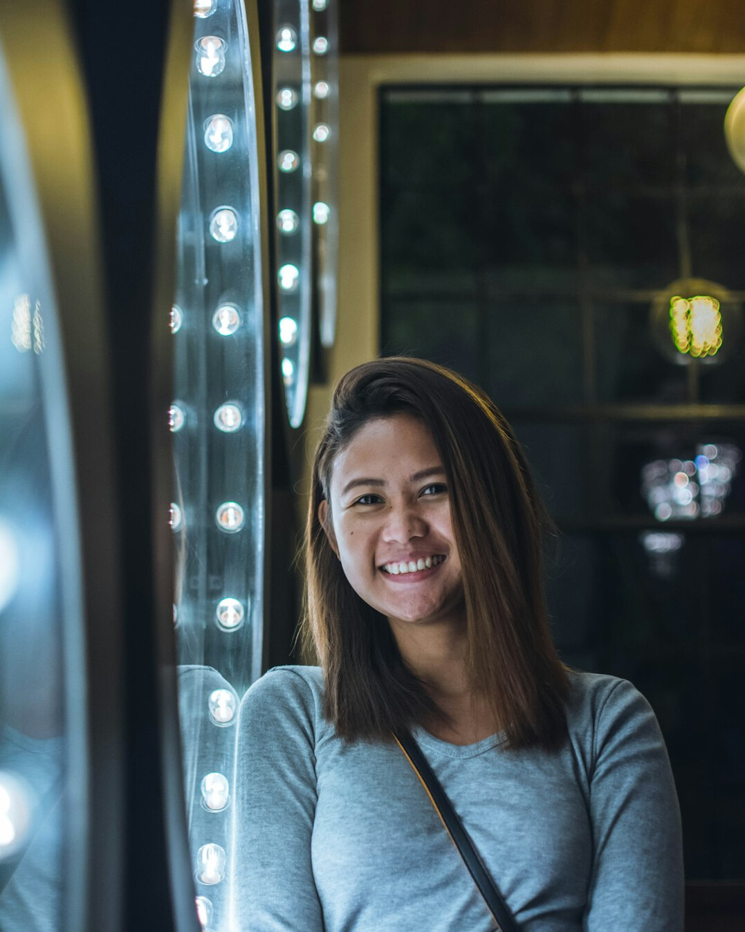 woman looking at mirror smiling